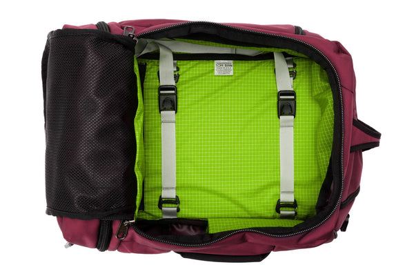An open Techonaut 30 with a Raspberry (reddish purple) exterior and a Kiwi (bright green) interior.